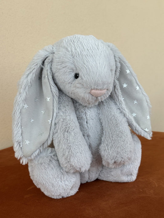 Peluche coniglietto Jellycat Medium Bashful Shimmer grigio chiaro con stelle argento coniglio-